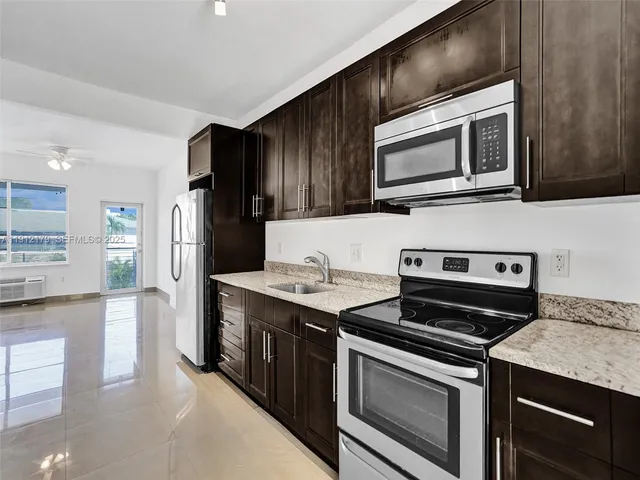 a kitchen with stainless steel appliances a refrigerator and a stove top oven