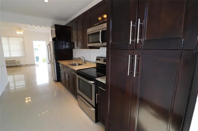 a kitchen with a stove microwave and sink