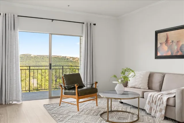 a living room with furniture and a large window