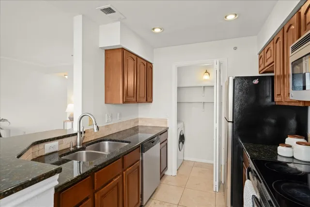 a kitchen that has a sink and a refrigerator