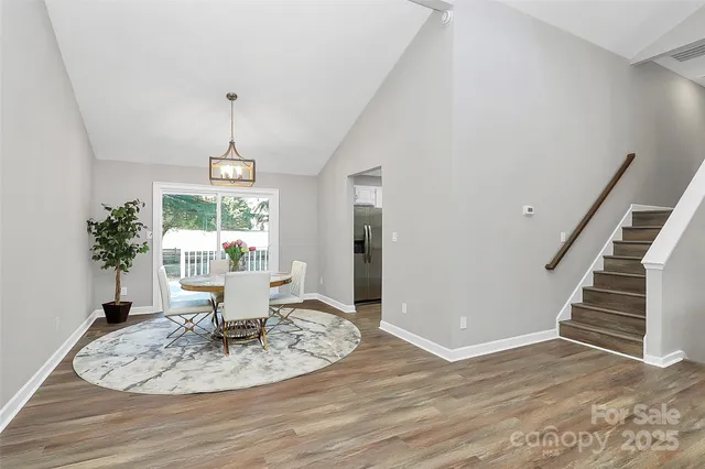 a view of a dining room with furniture wooden floor and entryway