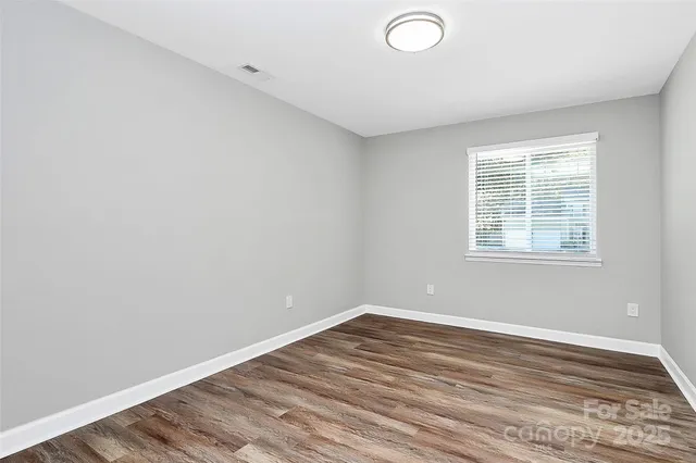a view of a room with wooden floor and fan