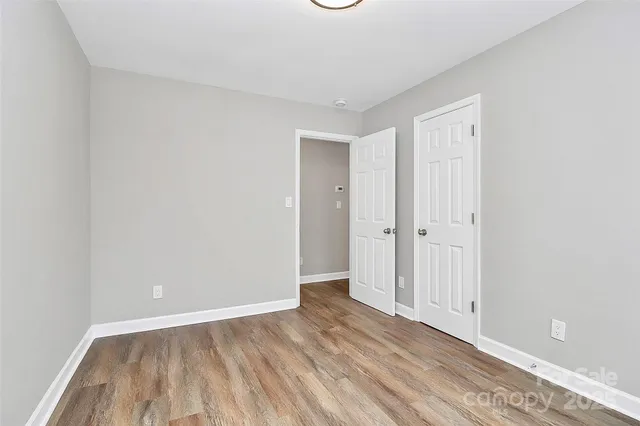 a view of an empty room and wooden floor