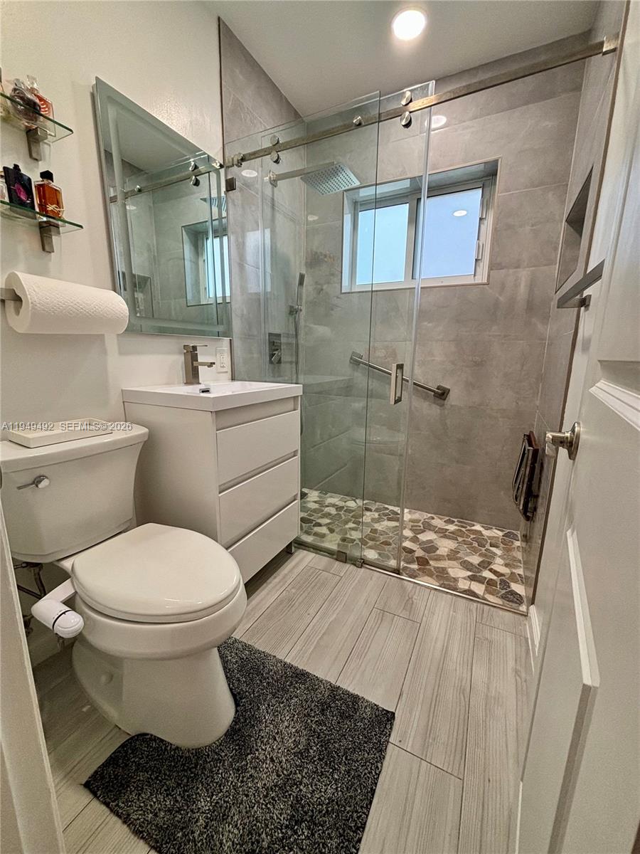 3521 Southwest 88th Court Miami, FL 33165 - Photo 3 of 12 a bathroom with a sink toilet and shower