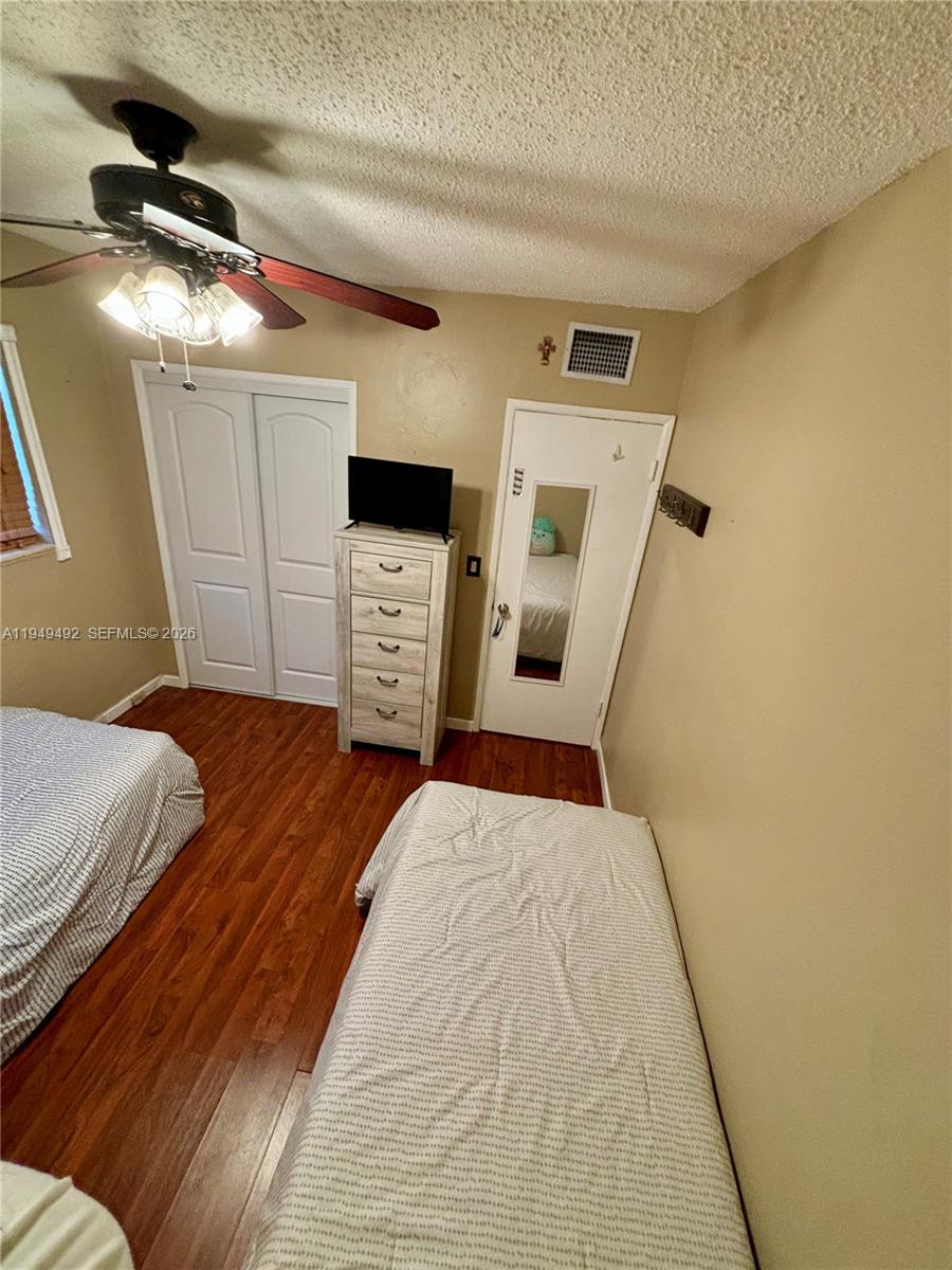 3521 Southwest 88th Court Miami, FL 33165 - Photo 6 of 12 a bedroom with a bed and cabinets