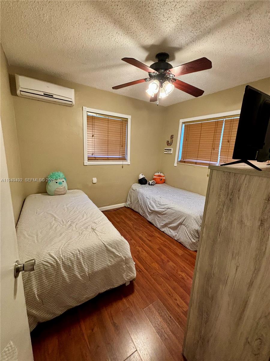 3521 Southwest 88th Court Miami, FL 33165 - Photo 7 of 12 a bedroom with a bed and wooden floor