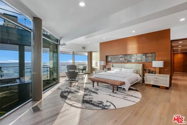 a living room with furniture wooden floor and a table