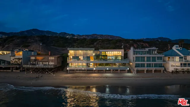 a view of a building with mountains in the background