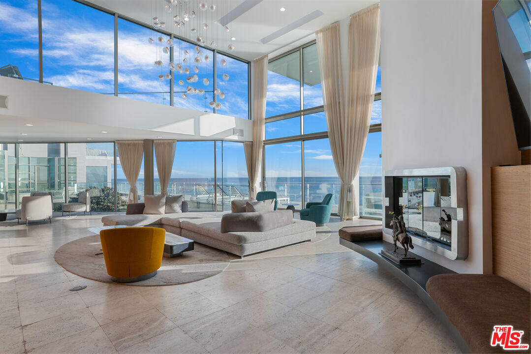 24434 Malibu Road Malibu, CA 90265 - Photo 10 of 29 a living room with furniture a large window and a potted plant