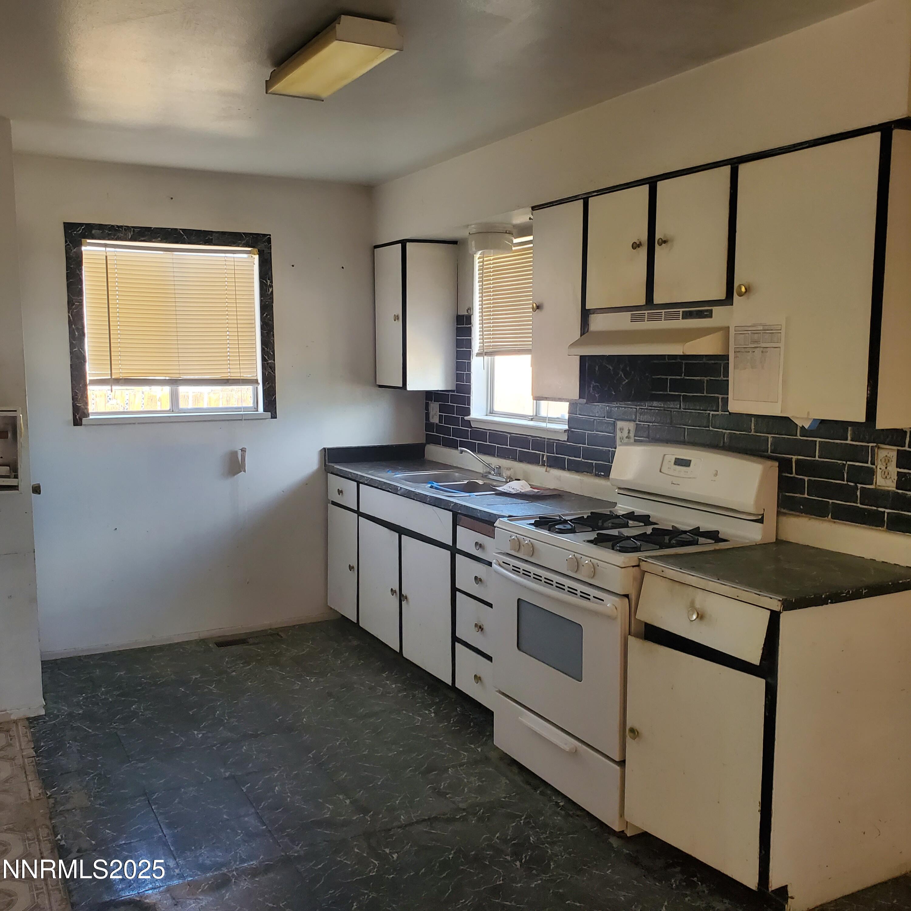 315 Pine Street Hawthorne, NV 89415 - Photo 2 of 6 a kitchen with a stove a sink and a window