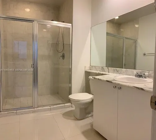 a bathroom with a shower sink and toilet