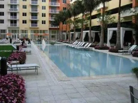a view of a swimming pool with outdoor seating