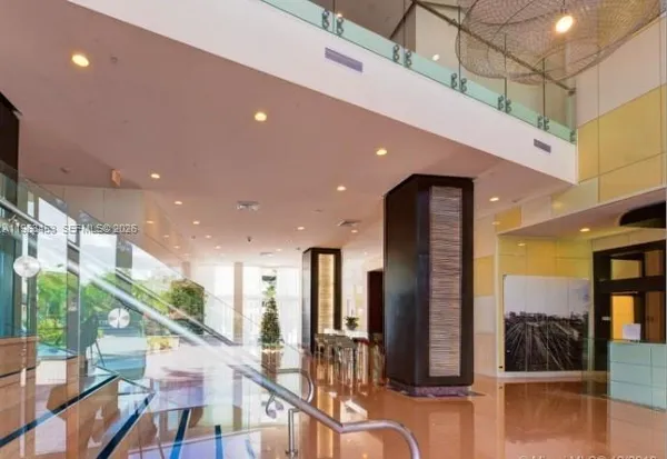 a lobby with furniture and floor to ceiling window