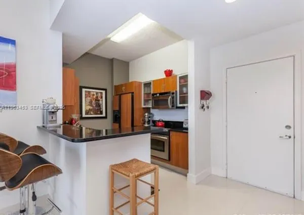 a view of kitchen and living room with furniture