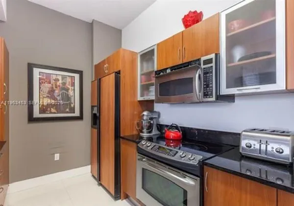 a kitchen with stainless steel appliances granite countertop a stove and cabinets