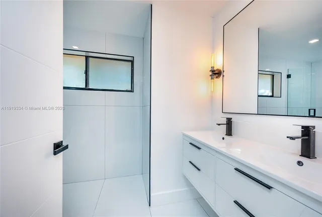 a bathroom with a double vanity sink and a mirror
