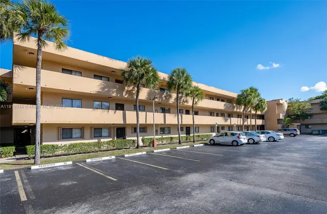 a view of building with cars parked