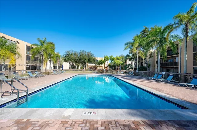a swimming pool with outdoor seating and yard