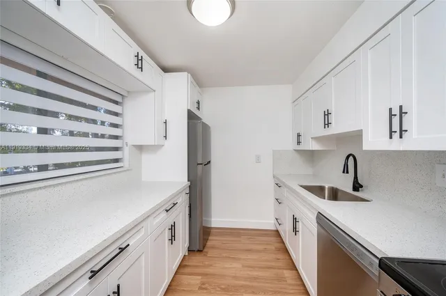 a kitchen with a sink and a refrigerator