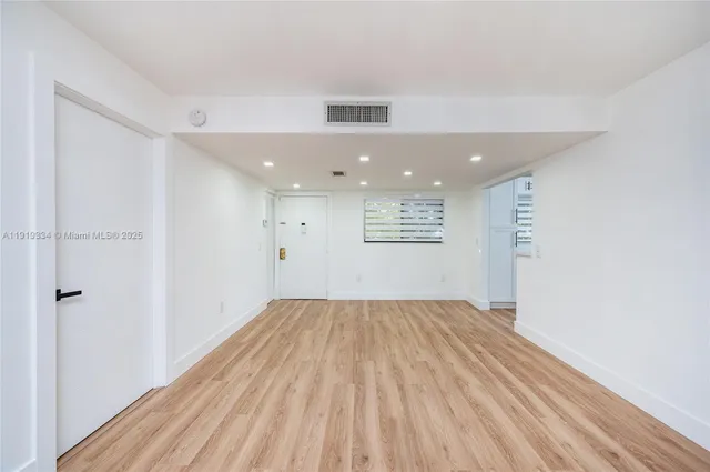 a view of an empty room and a window