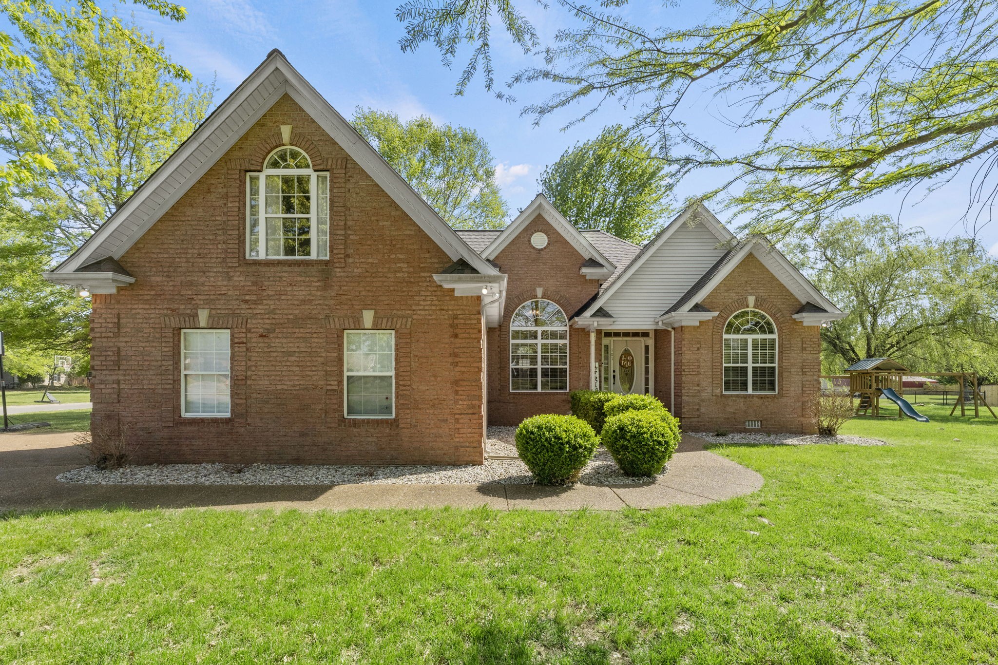 101 Lorelle Circle Portland, TN 37148 - Photo 3 of 21 a view of a yard in front of a house with large windows