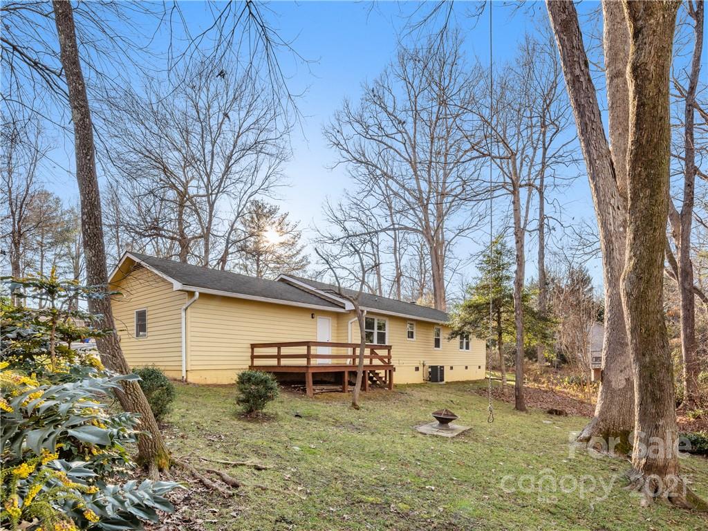 53 Westfield Road Fletcher, NC 28732 - Photo 22 of 24 a backyard of a house with garden and trees