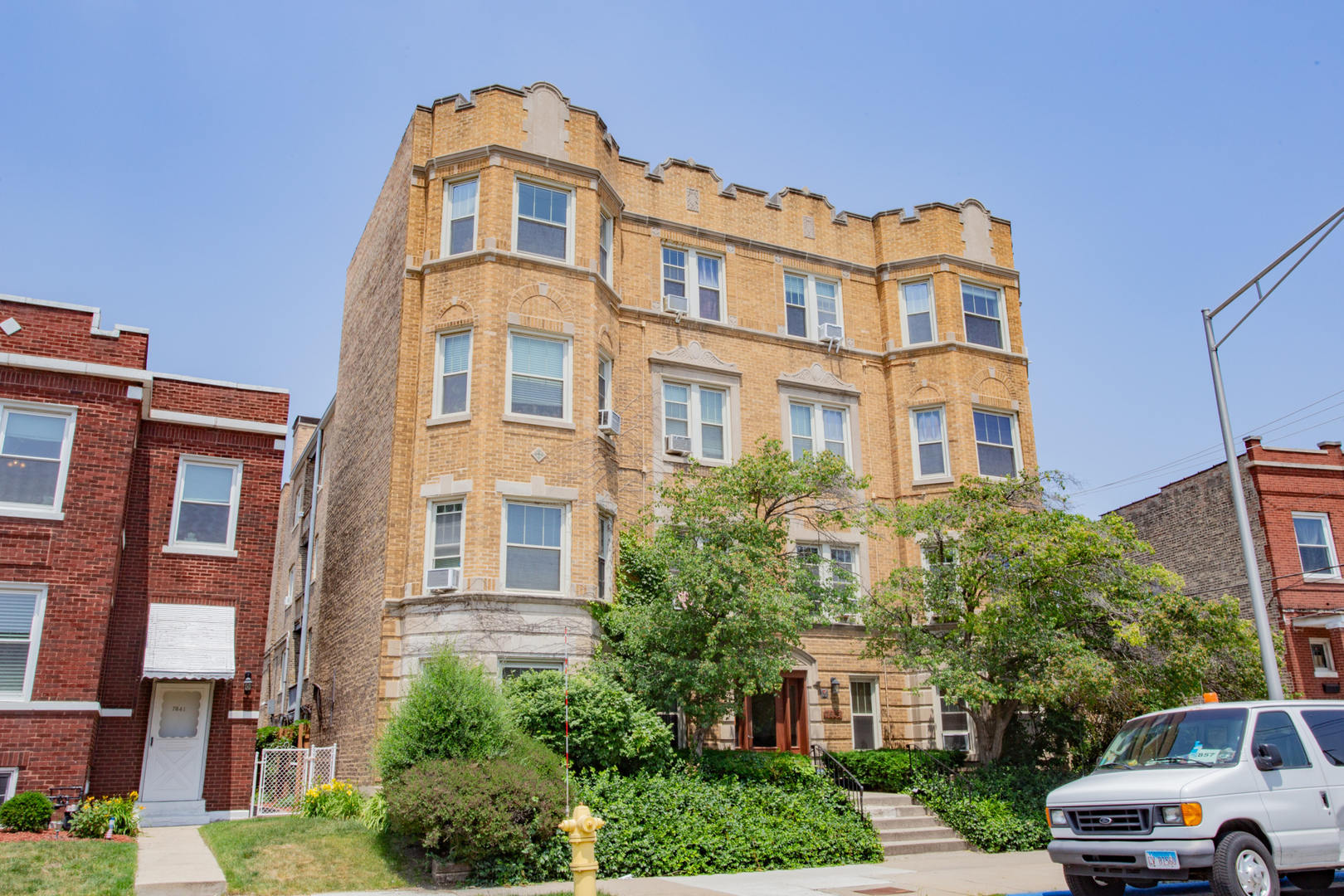 7639 Jackson Boulevard, Unit 1E Forest Park, IL 60130 - Photo 1 of 13 a front view of a residential apartment building with a yard