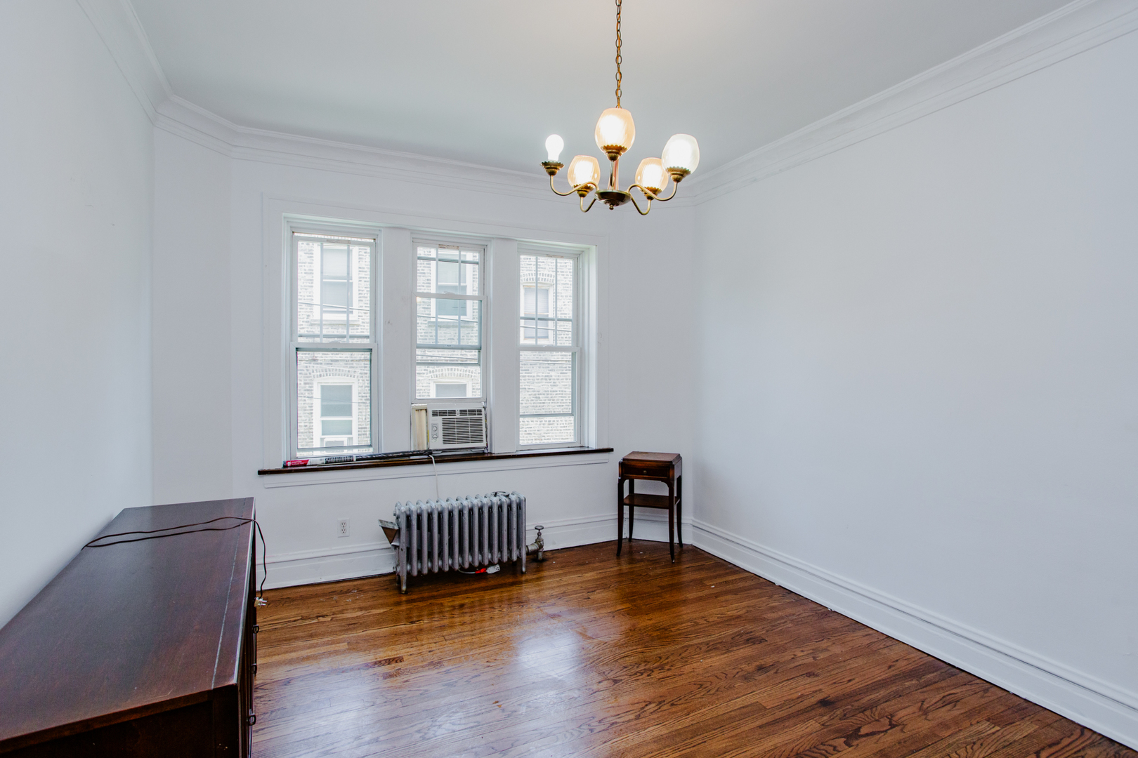 7639 Jackson Boulevard, Unit 1E Forest Park, IL 60130 - Photo 5 of 13 a view of a livingroom with furniture wooden floor and a window