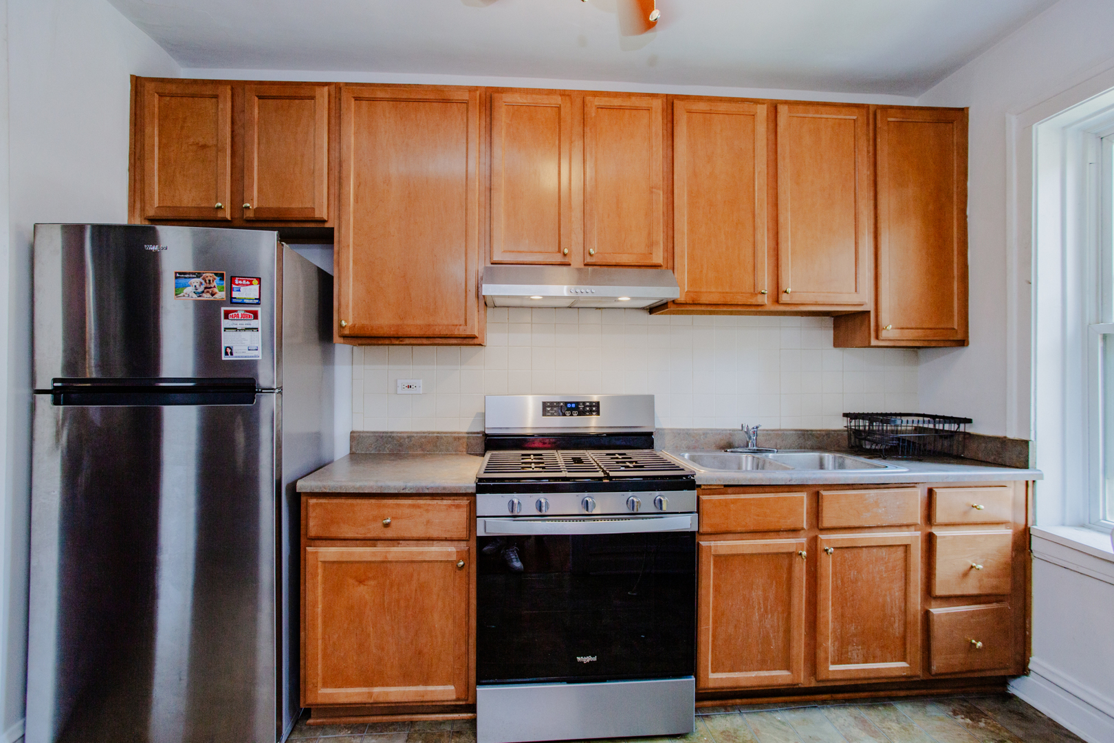 7639 Jackson Boulevard, Unit 1E Forest Park, IL 60130 - Photo 9 of 13 a kitchen with granite countertop a refrigerator stove and cabinets
