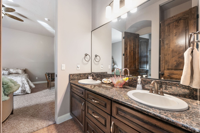 2376 Stone Crest Circle St. George, UT 84790 - Photo 35 of 61 Ensuite bathroom with double vanity, ceiling fan, and light carpet