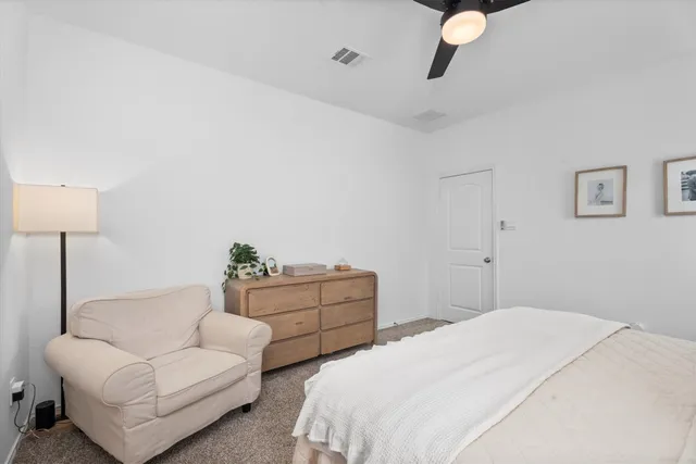 a bedroom with a large bed and a window
