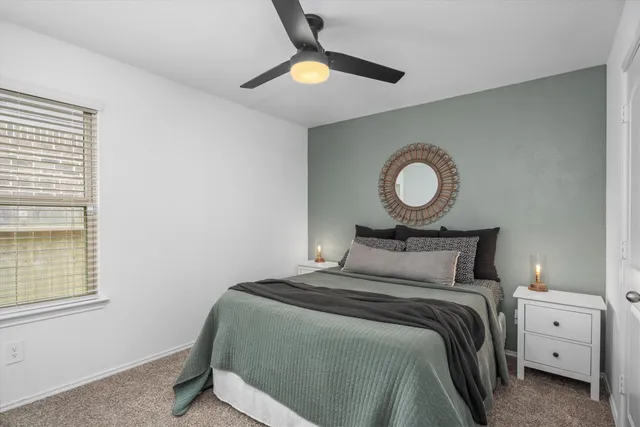 a bedroom with a bed and white cabinets