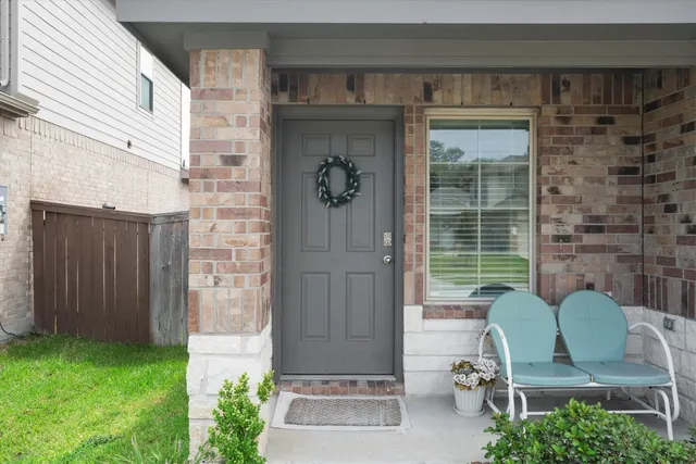 a view of backyard with outdoor seating and plants