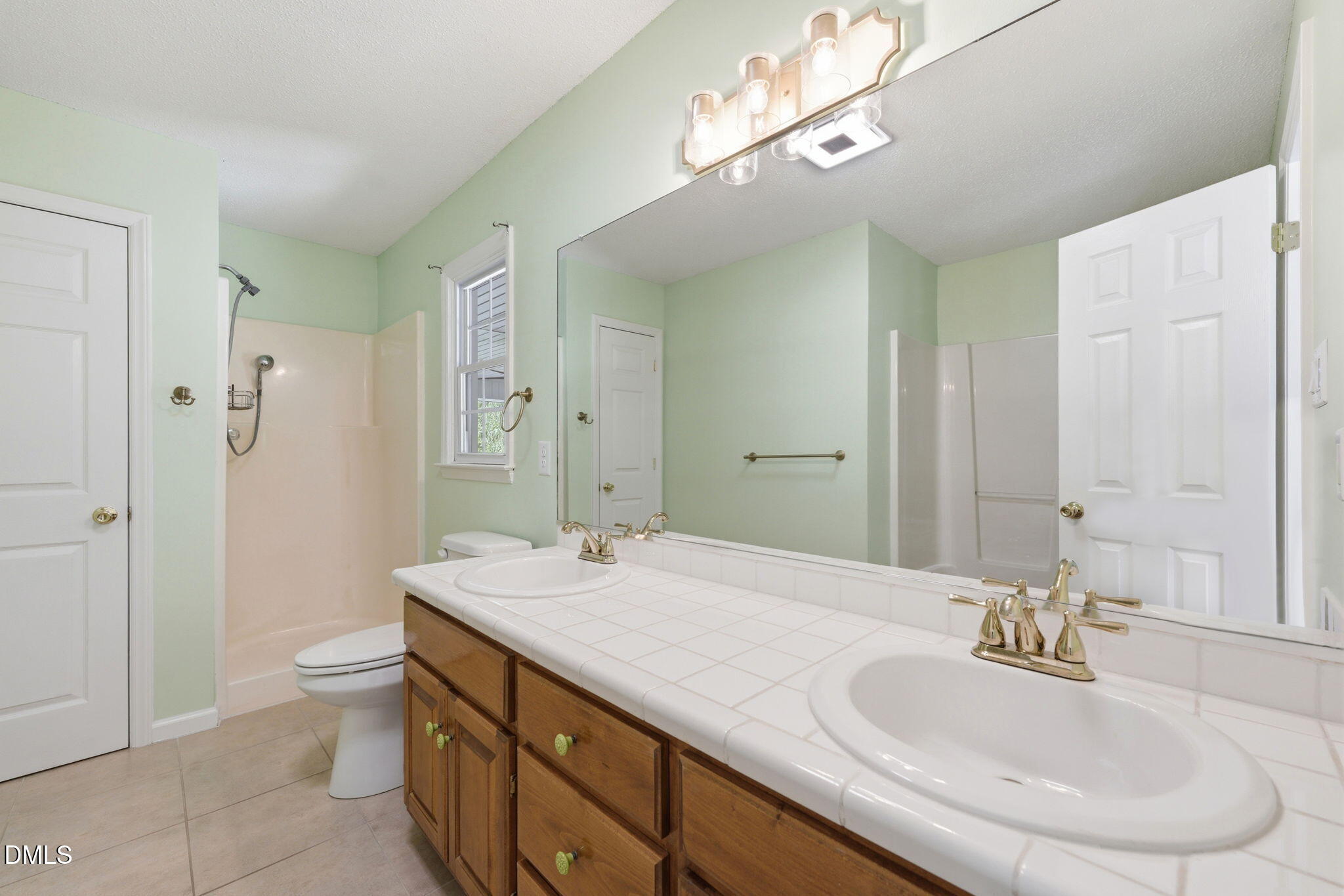 812 East Stagecoach Road Mebane, NC 27302 - Photo 19 of 25 a bathroom with a sink double vanity and a mirror