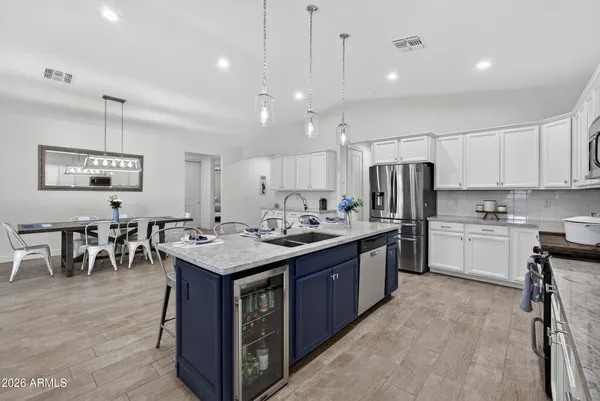 a kitchen with kitchen island granite countertop a sink counter top space stainless steel appliances and cabinets