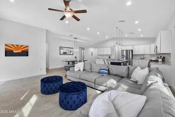 a living room with furniture a ceiling fan and a rug