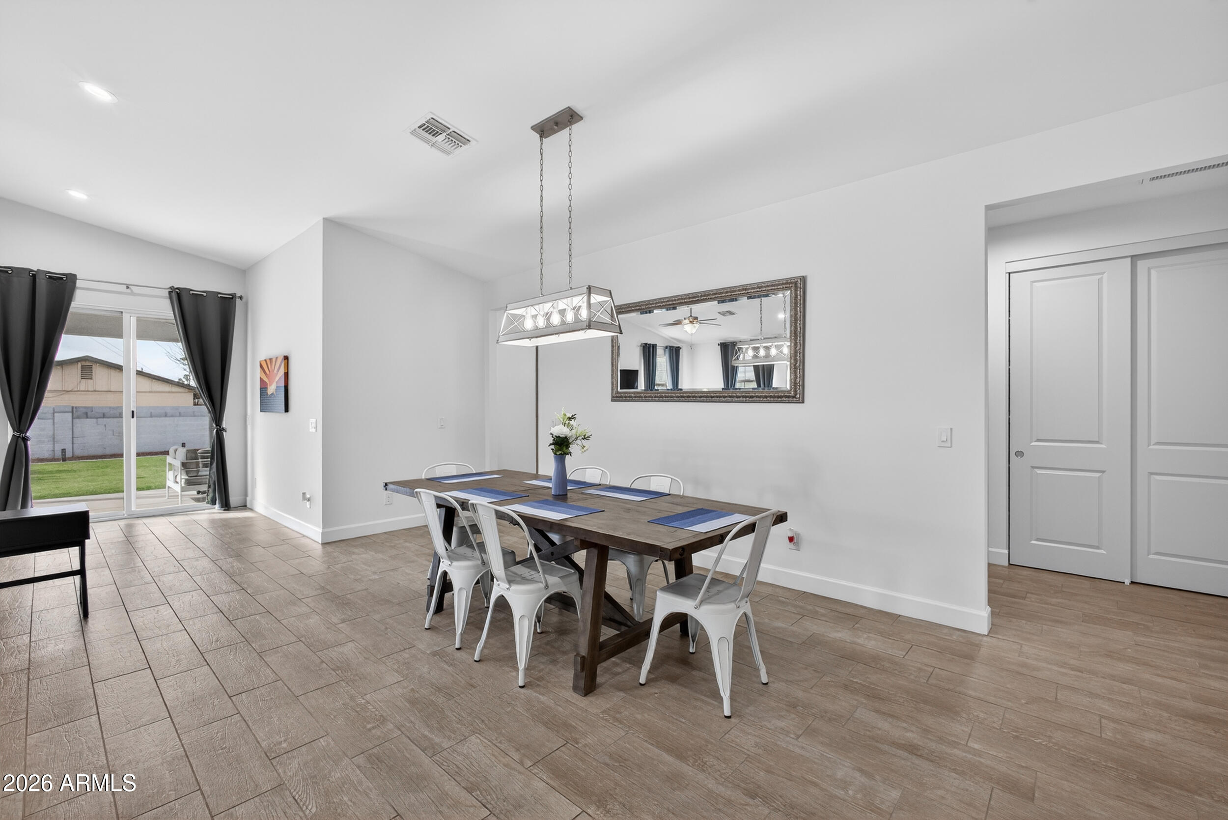 8942 North 15th Lane Phoenix, AZ 85021 - Photo 19 of 39 a view of a dining room with furniture window and wooden floor