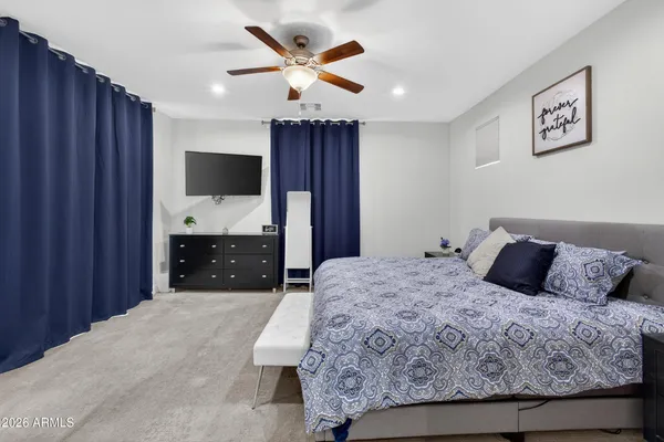 a bedroom with a large bed and a flat screen tv