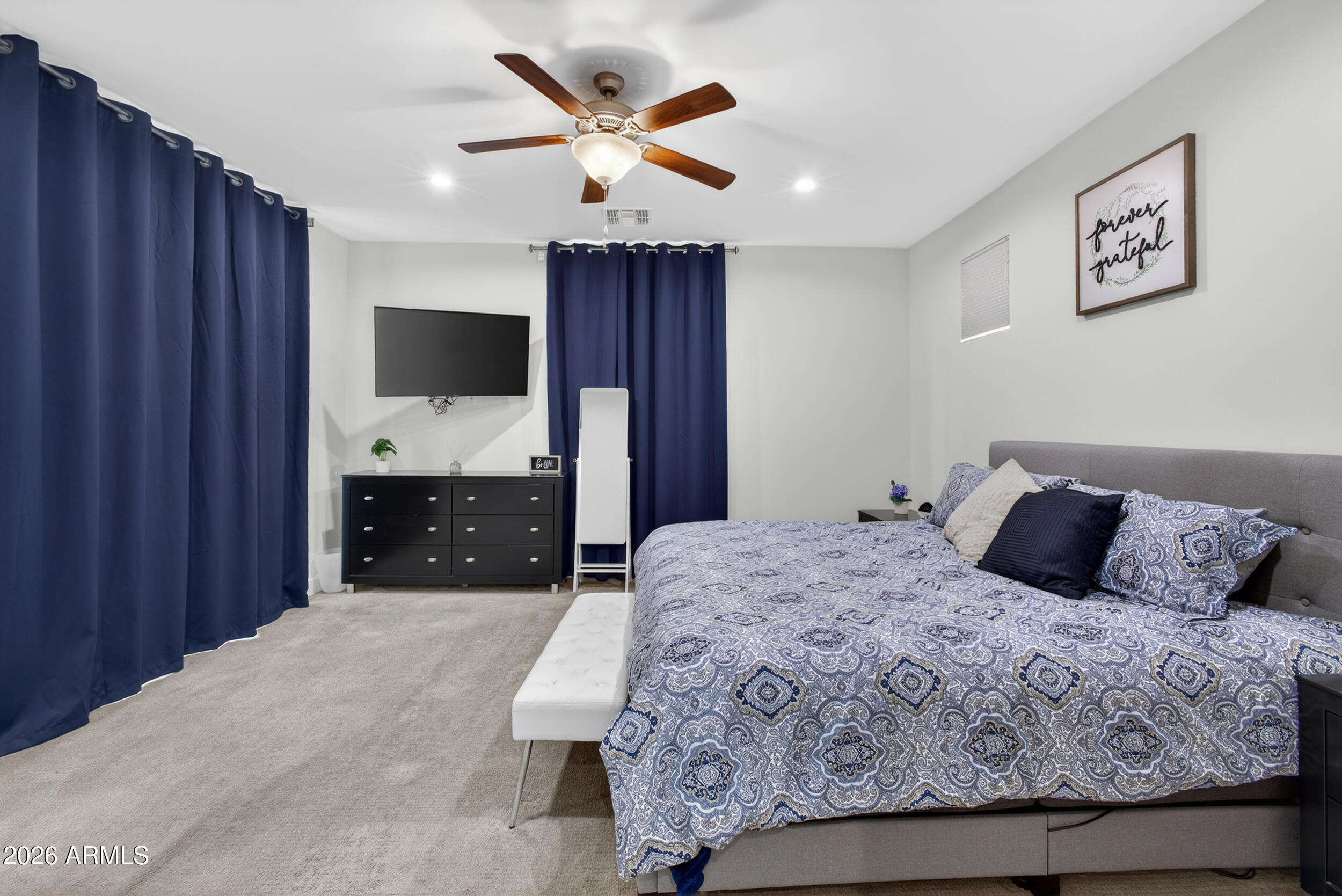 8942 North 15th Lane Phoenix, AZ 85021 - Photo 20 of 39 a bedroom with a large bed and a flat screen tv