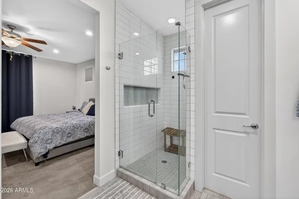 a bathroom with a tub shower and sink