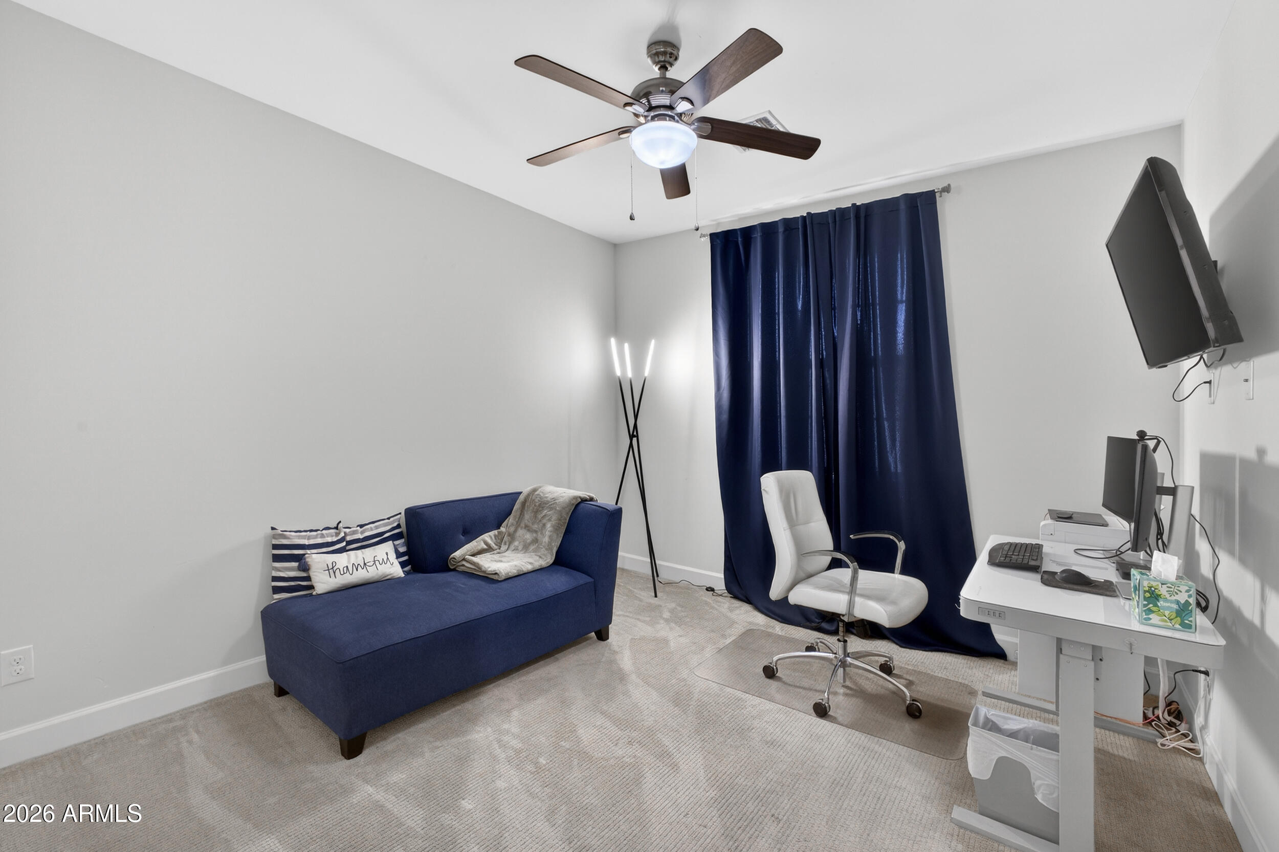 8942 North 15th Lane Phoenix, AZ 85021 - Photo 28 of 39 a living room with furniture a flat screen tv and a window
