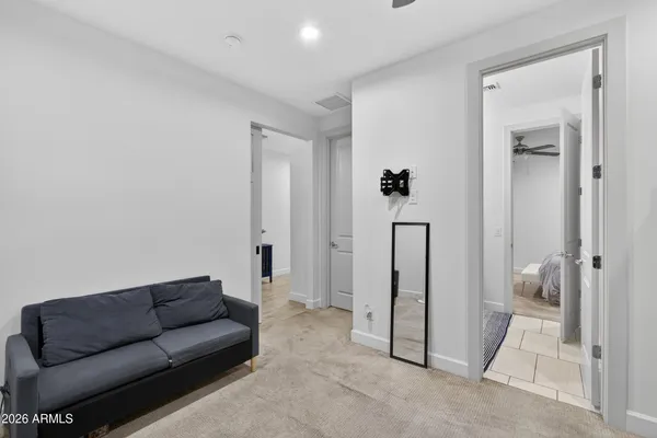 a living room with furniture and a glass door