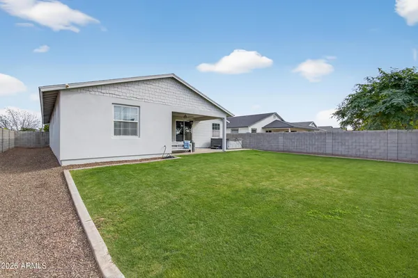a view of a house with a backyard
