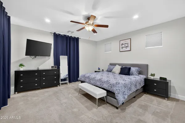 a bedroom with a bed and a flat screen tv