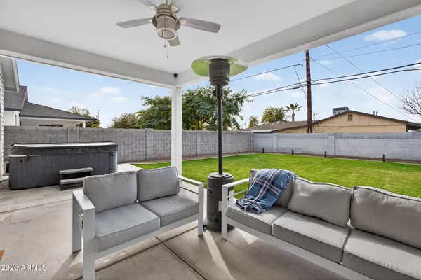 a roof deck with couches and potted plants