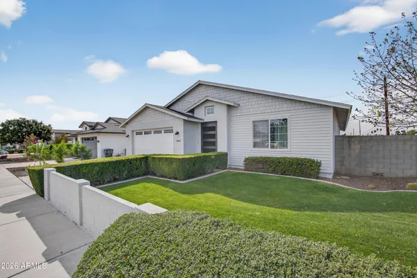 a view of a house with a yard and sitting area