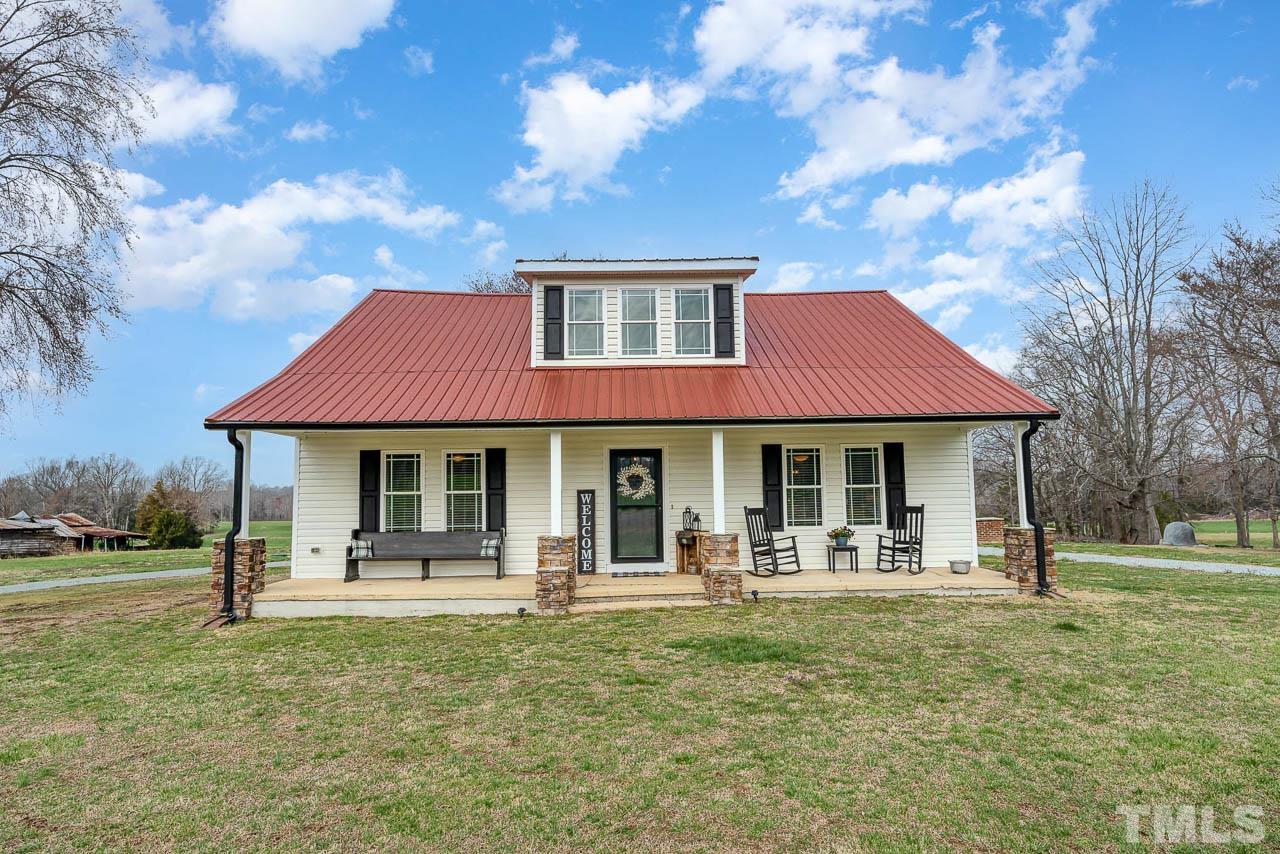 2369 Lonnie Gentry Road Roxboro, NC 27574 - Photo 1 of 24 a front view of a house with garden