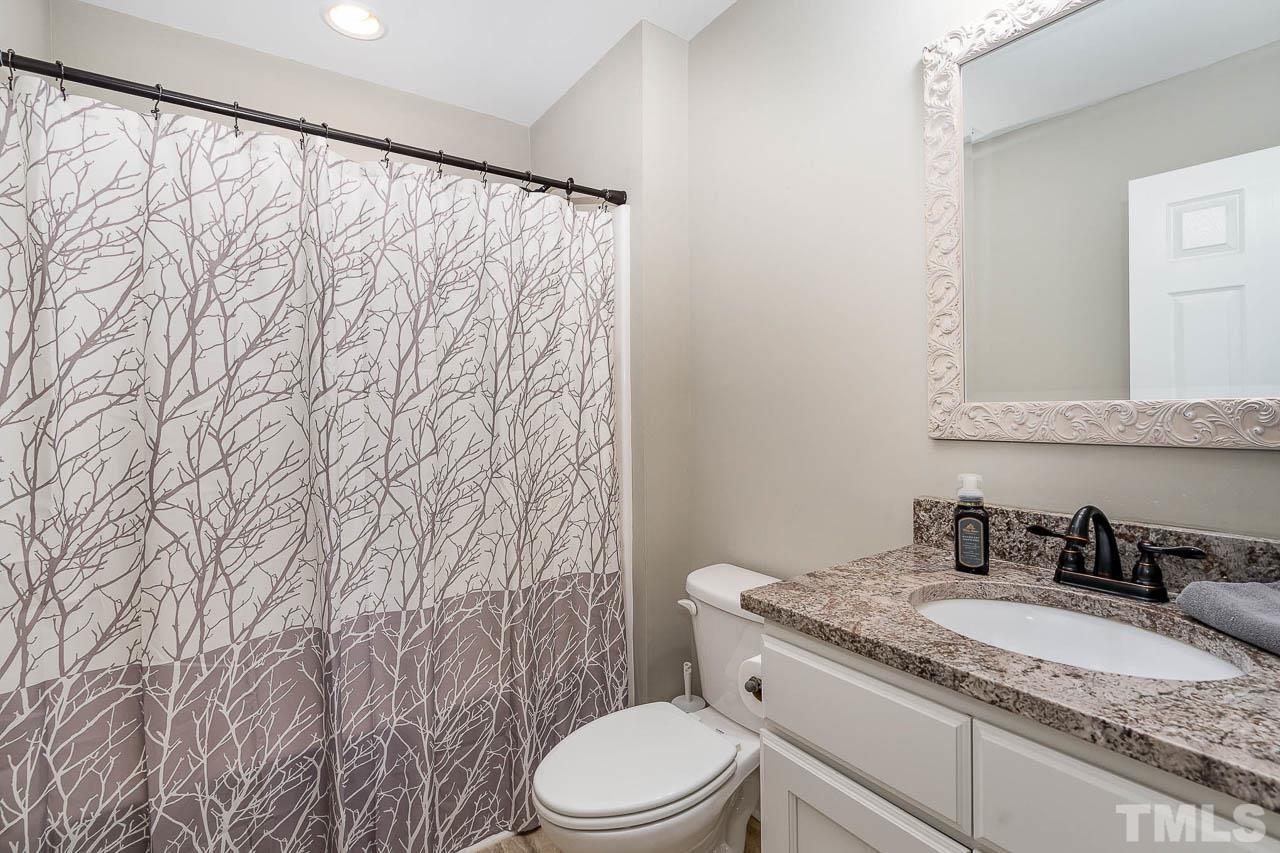 2369 Lonnie Gentry Road Roxboro, NC 27574 - Photo 13 of 24 a bathroom with a granite countertop sink and a mirror
