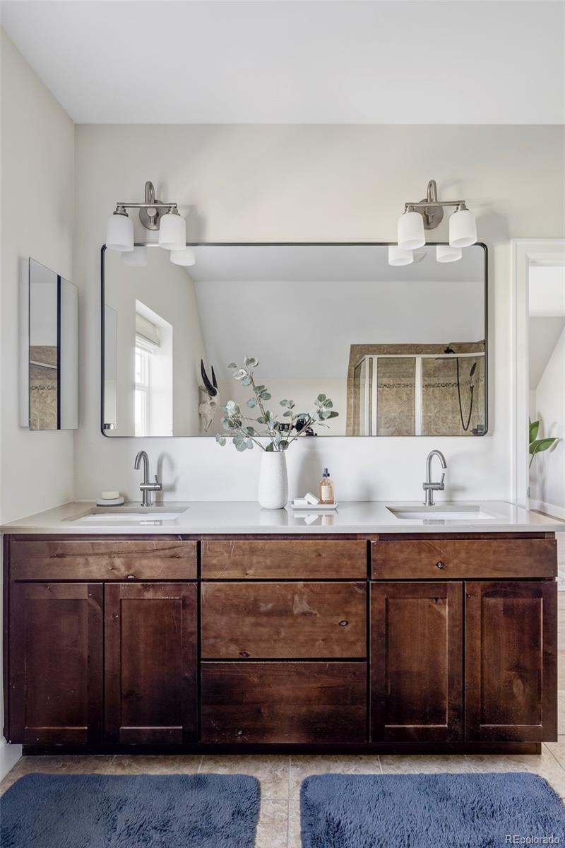 2908 Ironton Street Denver, CO 80238 - Photo 16 of 30 a bathroom with a granite countertop sink and a mirror