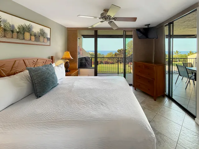 a spacious bedroom with a large bed and a large window